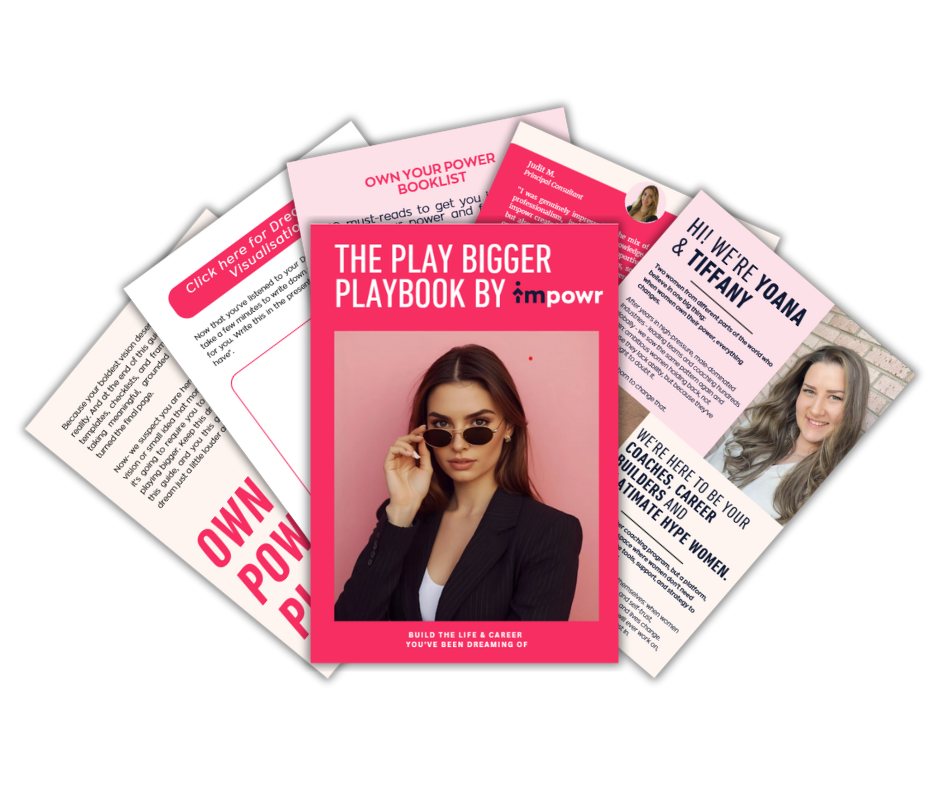 Stack of colorful booklets with "The Play Bigger Playbook by impowr" cover showing a woman in sunglasses. Background text on empowerment.