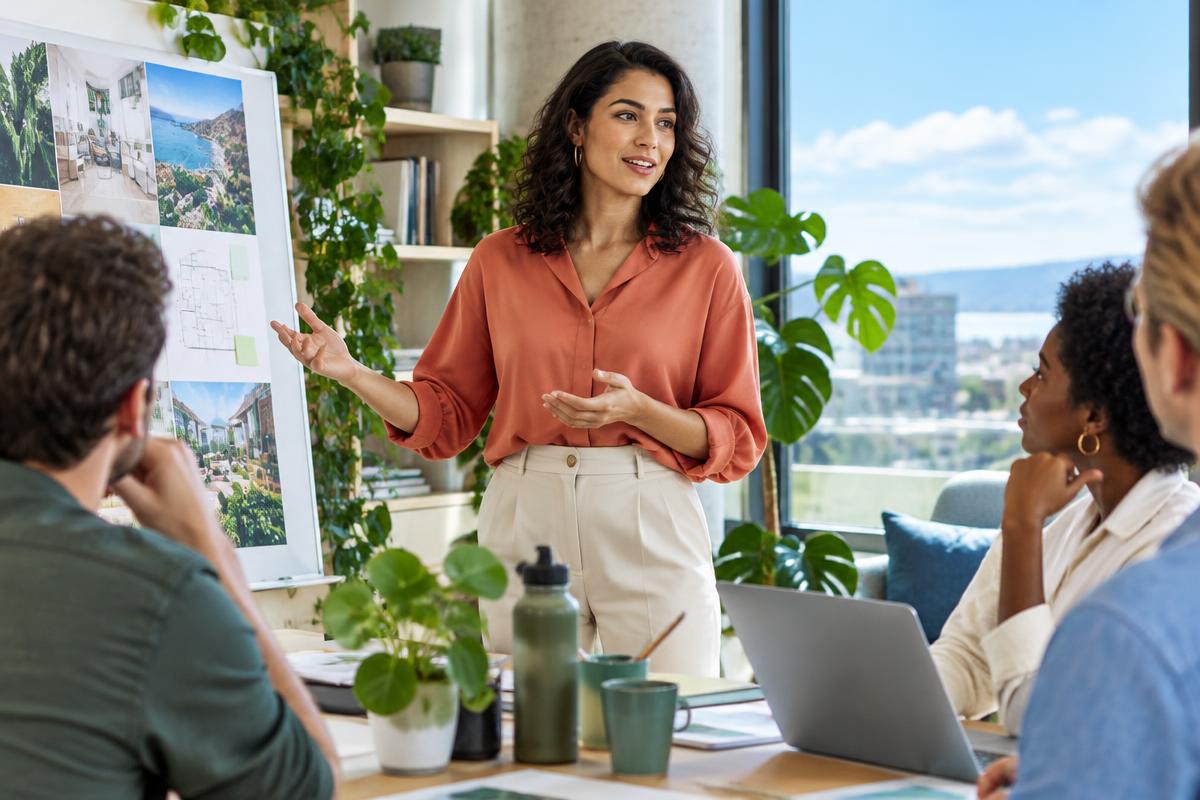 Woman presenting her project to colleagues in a sunlit office
